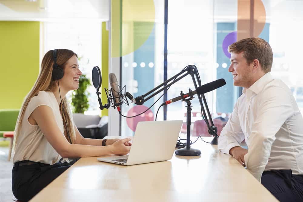 A podcast hosts asks her interviewee questions